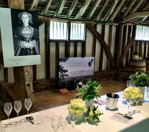 a table with empty glasses, decorated with white flowers in a barn