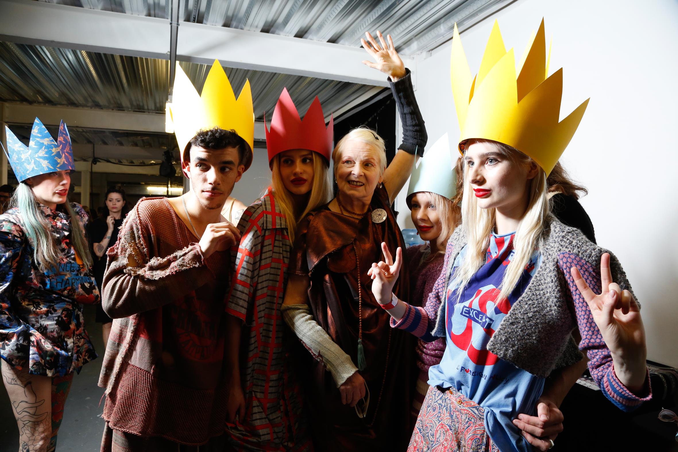 group of fashion models stood with the fashion designer