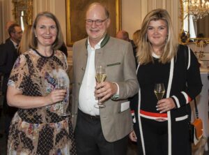 a man and two women each holding a wine glass