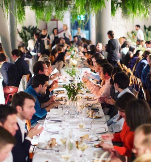 people dining in a large hall at an event