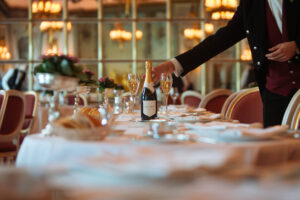 wine being presented by a waiter at a set table